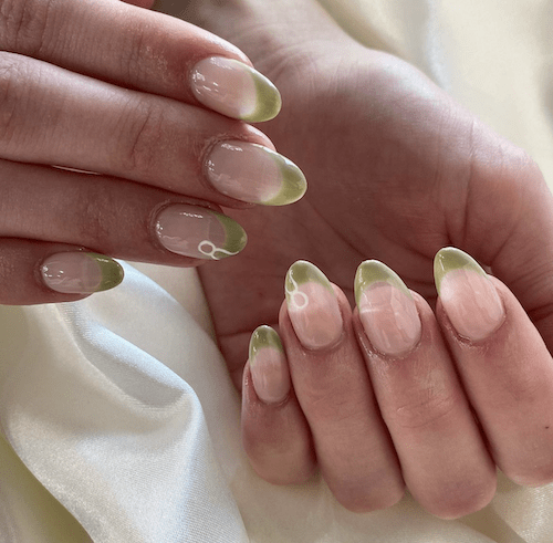 Olive green French tips with a Taurus glyph
